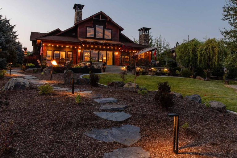 Outdoor living landscape with lighting by Copper Creek Landscaping