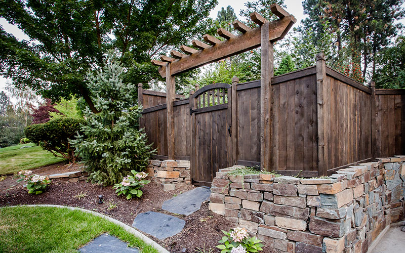 wood fence and arbor portal backyard entrance